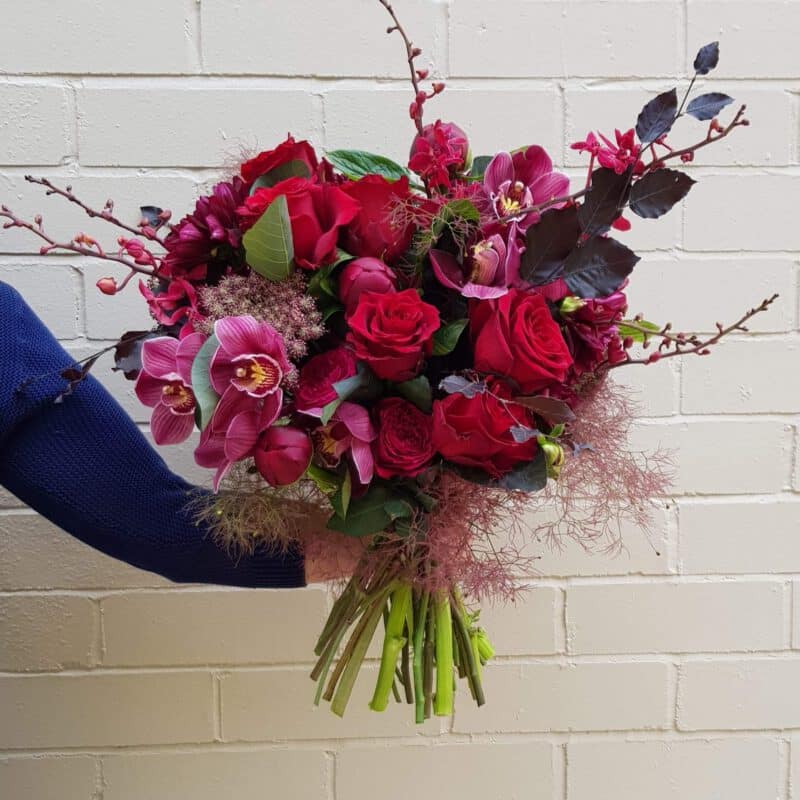 Red rose and orchid bouquet available for delivery. - The Village Florist Hunters Hill