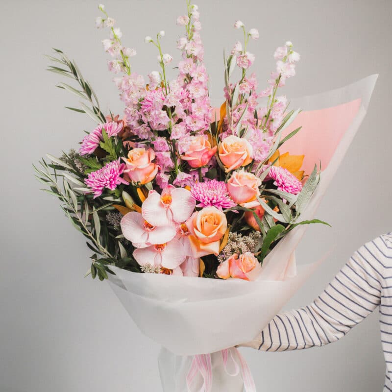 Pink and peach floral arrangement with orchids and roses. - The Village Florist Hunters Hill