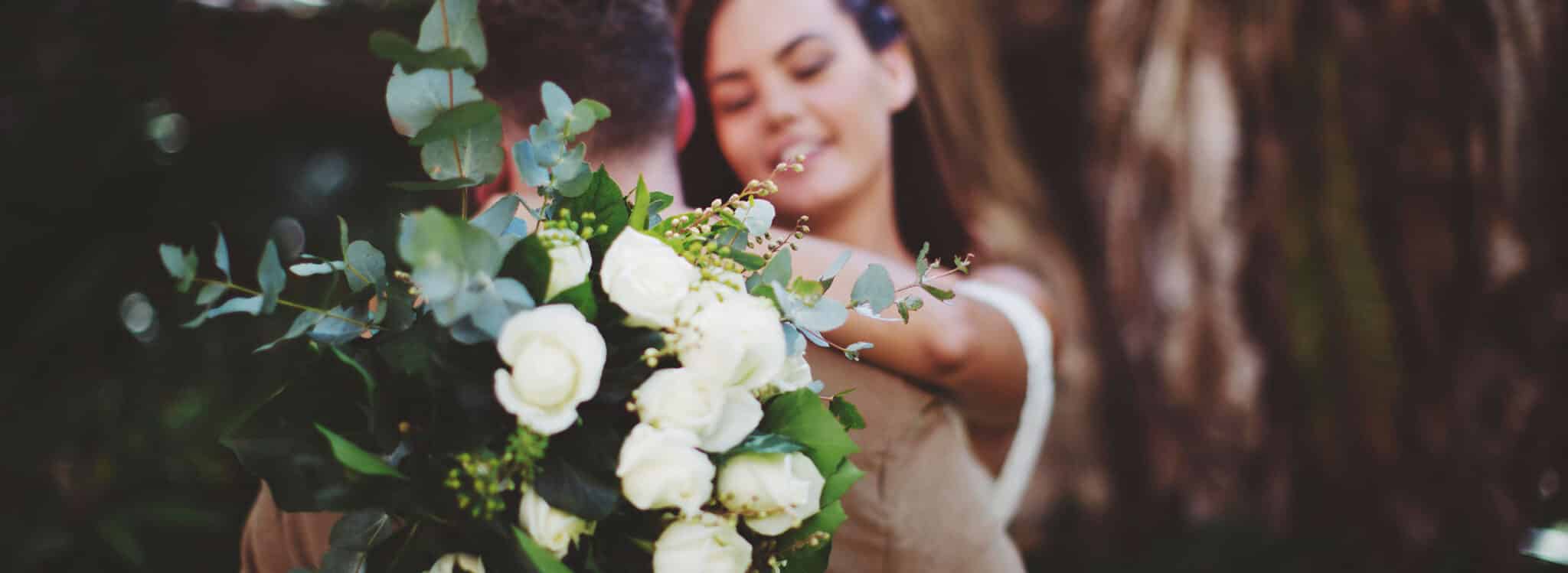 Couple embracing with white roses - The Village Florist Hunters Hill