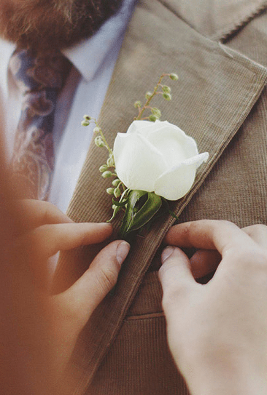 Groom getting a white rose boutonniere pinned - The Village Florist Hunters Hill