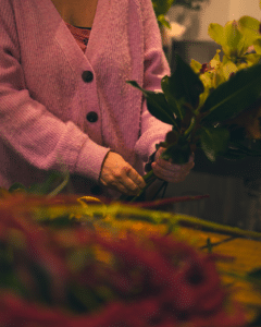 Florist arranging pink cardigan and flowers - The Village Florist Hunters Hill