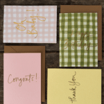 Four handwritten greeting cards on a wooden background. - The Village Florist Hunters Hill