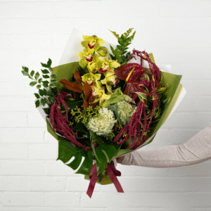 Yellow orchids, red anthurium, and lush greenery bouquet available for delivery. - The Village Florist Hunters Hill